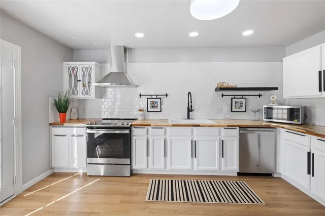 a kitchen with stainless steel appliances granite countertop a stove and a sink