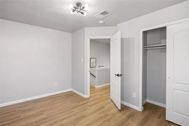 a view of a room with wooden floor