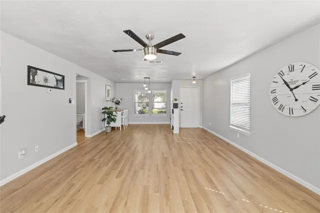 a view of empty room with wooden floor