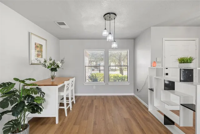 a view of a dining room with furniture wooden floor and a chandelier