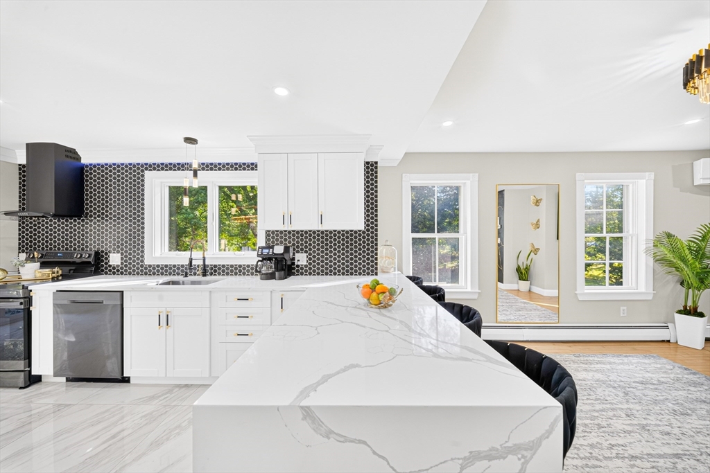 24 Miller Road Wilmington, MA 01887 - Photo 11 of 40 a large white kitchen with a window