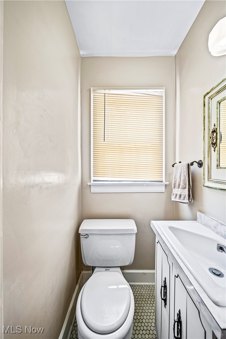8219 Midland Road Mentor, OH 44060 - Photo 15 of 34 Bathroom with tile patterned floors, toilet, and vanity