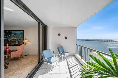 a view of a balcony with chair and a potted plant