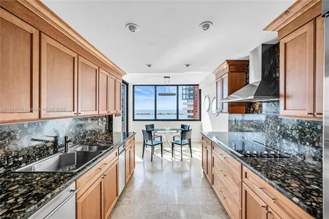 a kitchen with stainless steel appliances granite countertop a stove a sink and a refrigerator