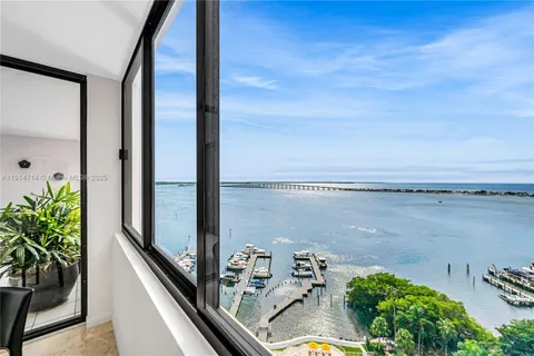 a living room with furniture and a floor to ceiling window