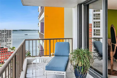 a bathroom with a granite countertop sink a toilet a shower and a mirror