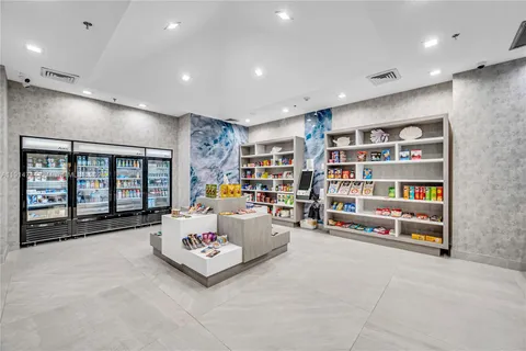an aerial view of a swimming pool with seating area