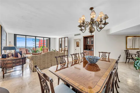 a view of a dining room with furniture wooden floor and chandelier