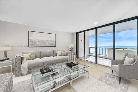 a living room with furniture and a floor to ceiling window