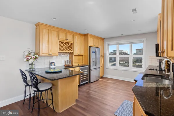 a living room with furniture a flat screen tv and a large window