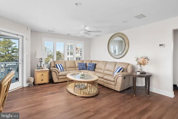 a dining room with furniture wooden floor a rug and a painting