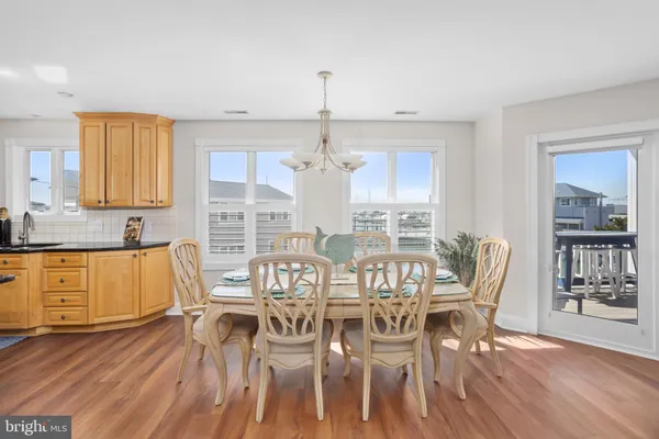 a kitchen with stainless steel appliances granite countertop wooden floor and large window