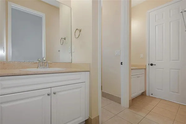 a view of a house with a big yard and large trees