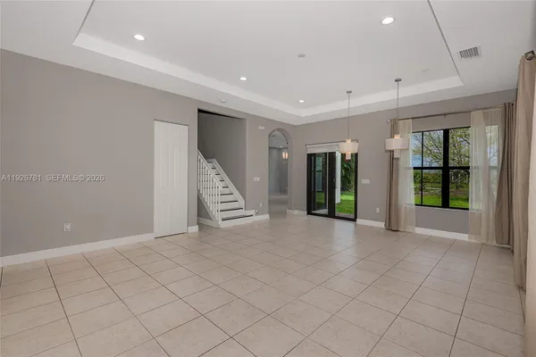 an empty room with windows and stairs