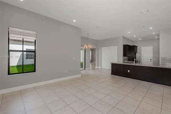 a kitchen with stainless steel appliances kitchen island granite countertop a refrigerator and a stove top oven