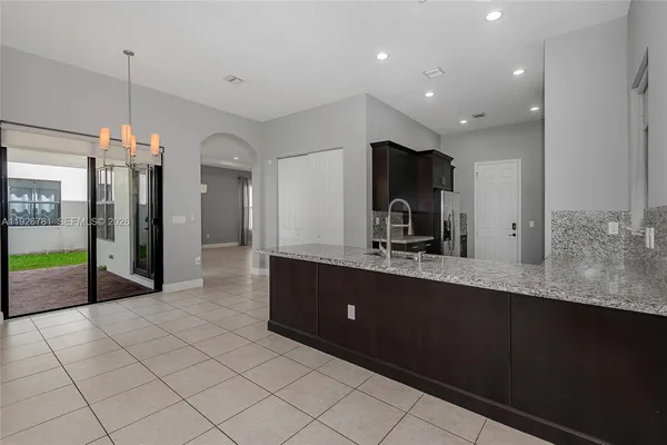 a kitchen with stainless steel appliances granite countertop a sink and a counter space