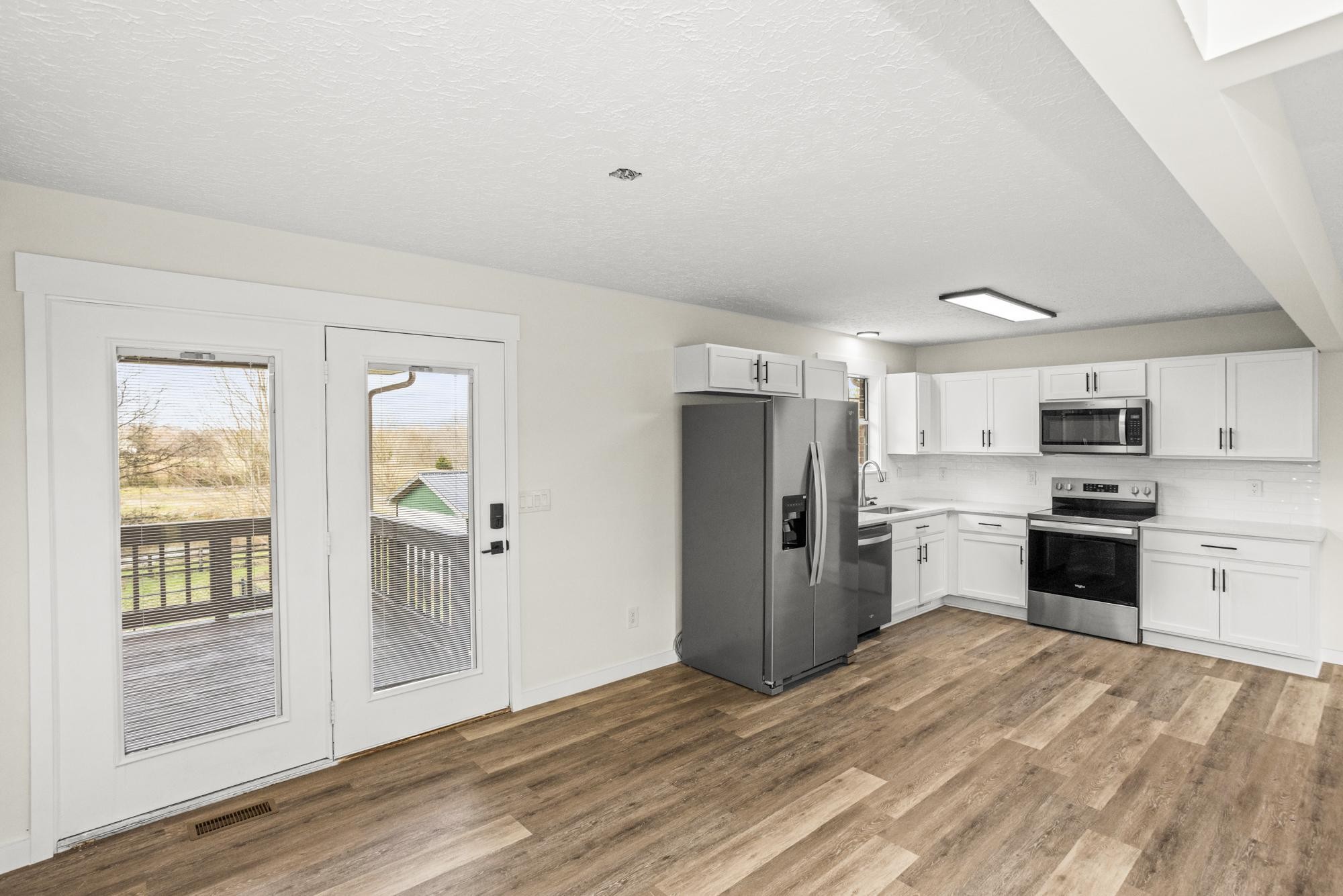 1053 Johns Road Joelton, TN 37080 - Photo 12 of 83 a kitchen with stainless steel appliances a refrigerator and a stove top oven
