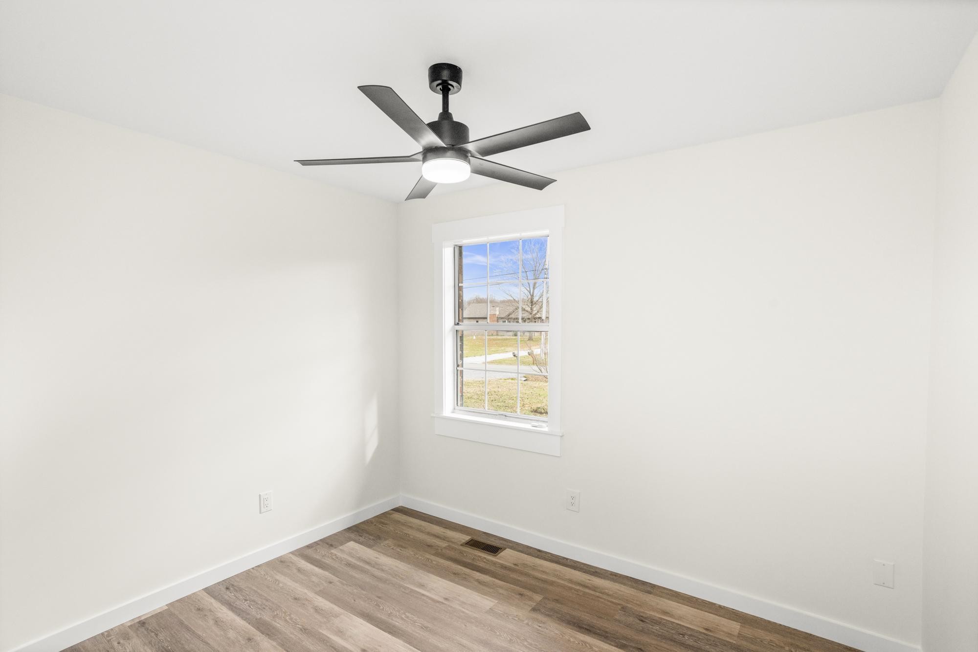 1053 Johns Road Joelton, TN 37080 - Photo 17 of 83 a view of a big room with wooden floor closet and fan