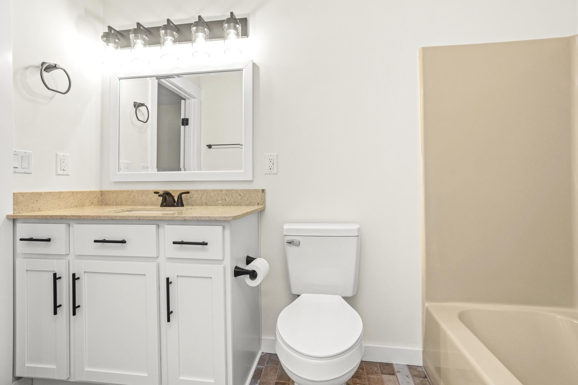 1053 Johns Road Joelton, TN 37080 - Photo 31 of 83 a bathroom with a sink a toilet and a mirror