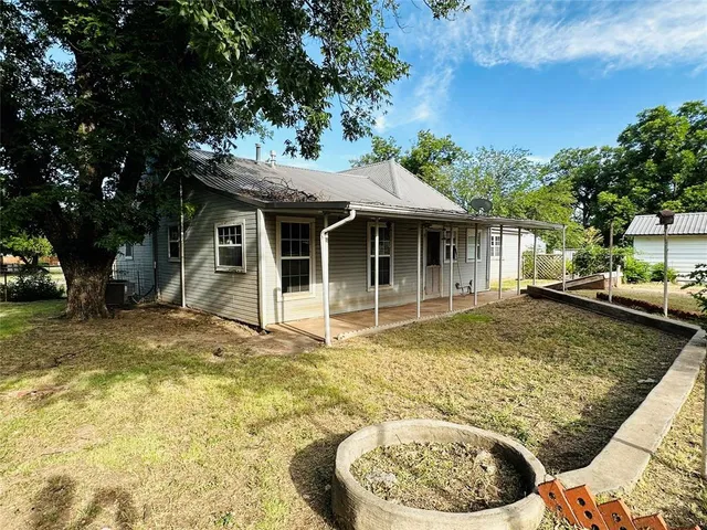 a view of a house with pool and sitting area