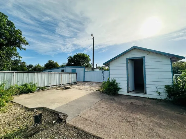 a view of backyard with deck and outdoor seating