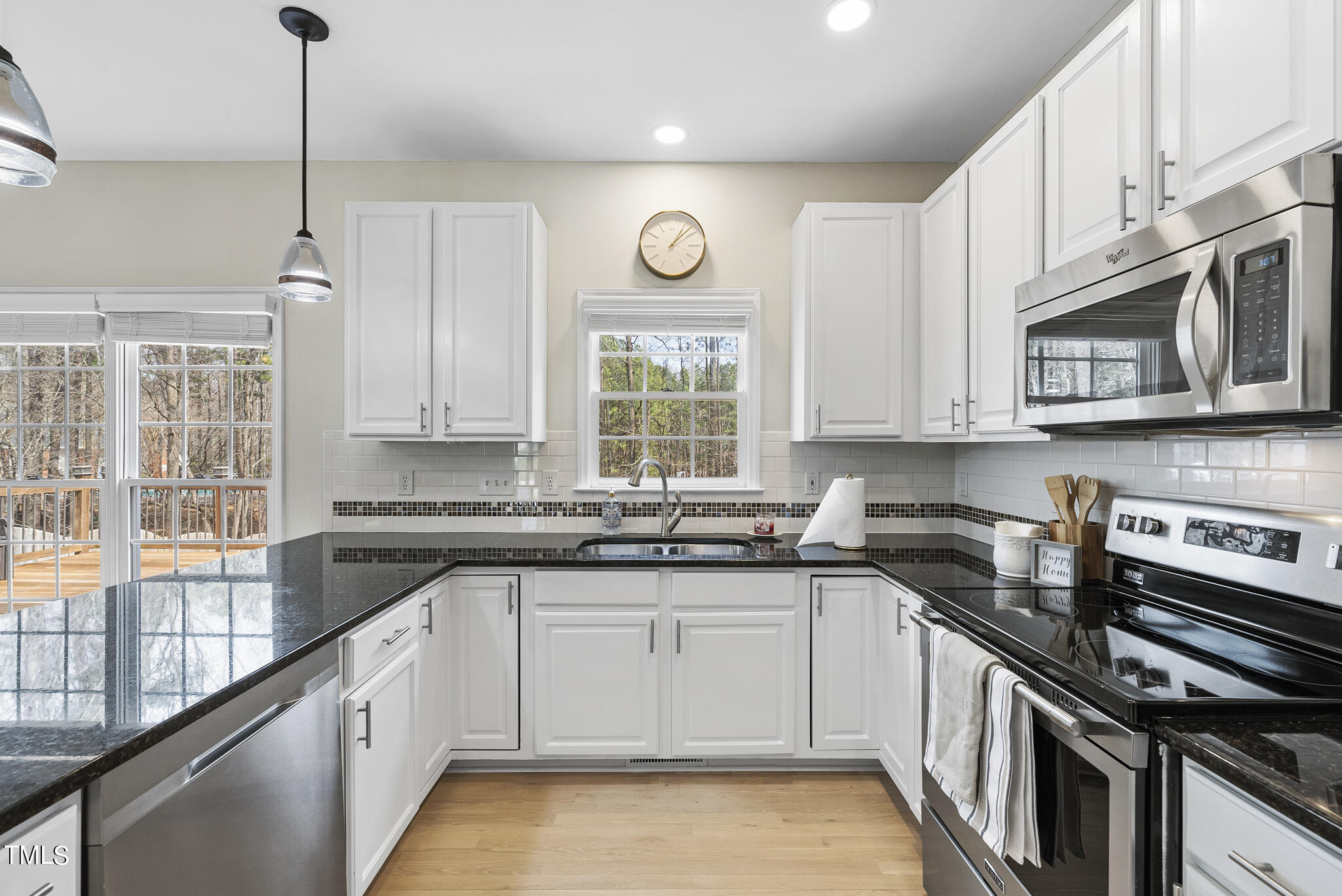 9013 Miranda Drive Raleigh, NC 27617 - Photo 14 of 41 a kitchen with stainless steel appliances granite countertop a stove sink microwave and cabinets