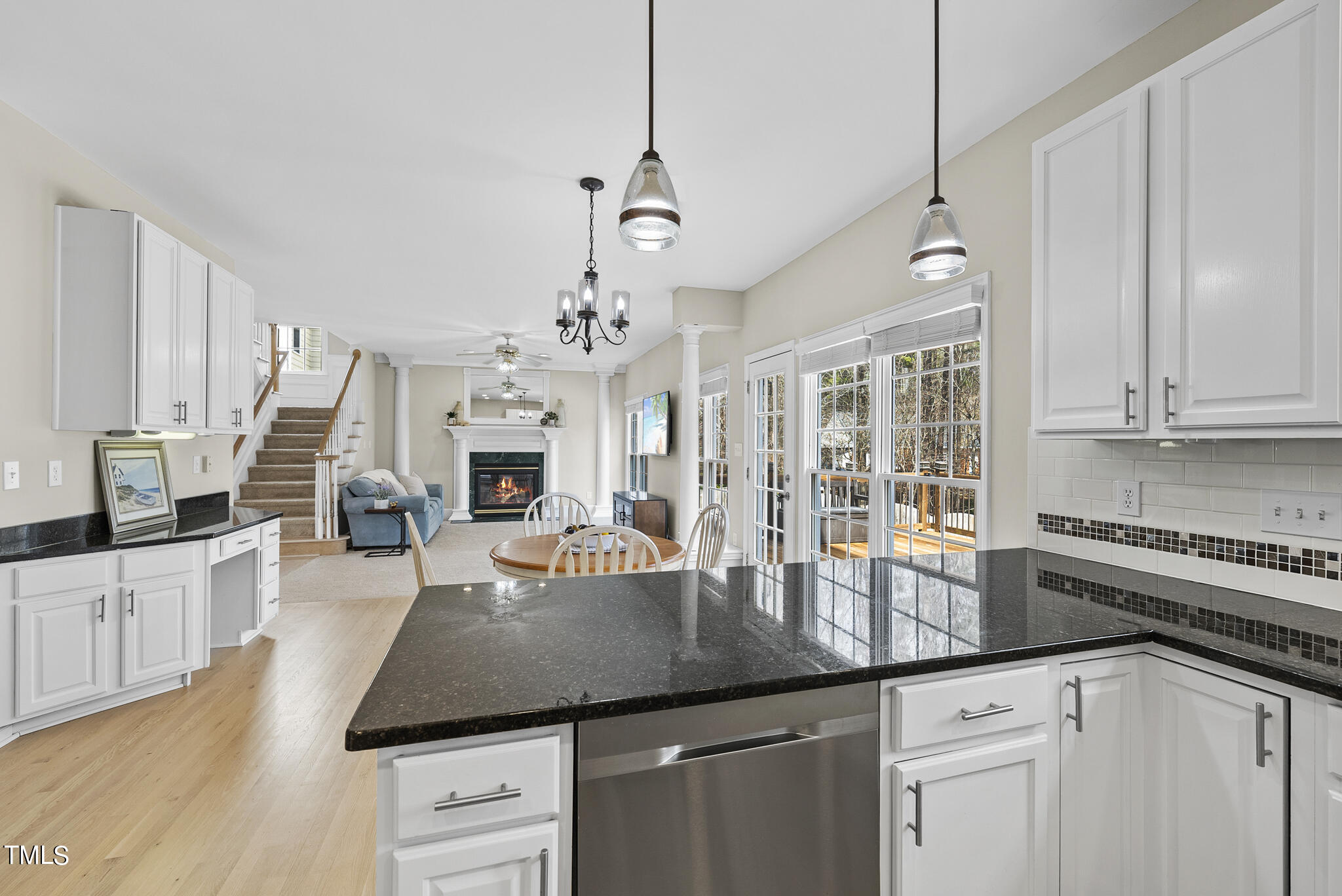 9013 Miranda Drive Raleigh, NC 27617 - Photo 15 of 41 a kitchen with stainless steel appliances granite countertop a stove a sink dishwasher a refrigerator and white cabinets with wooden floor
