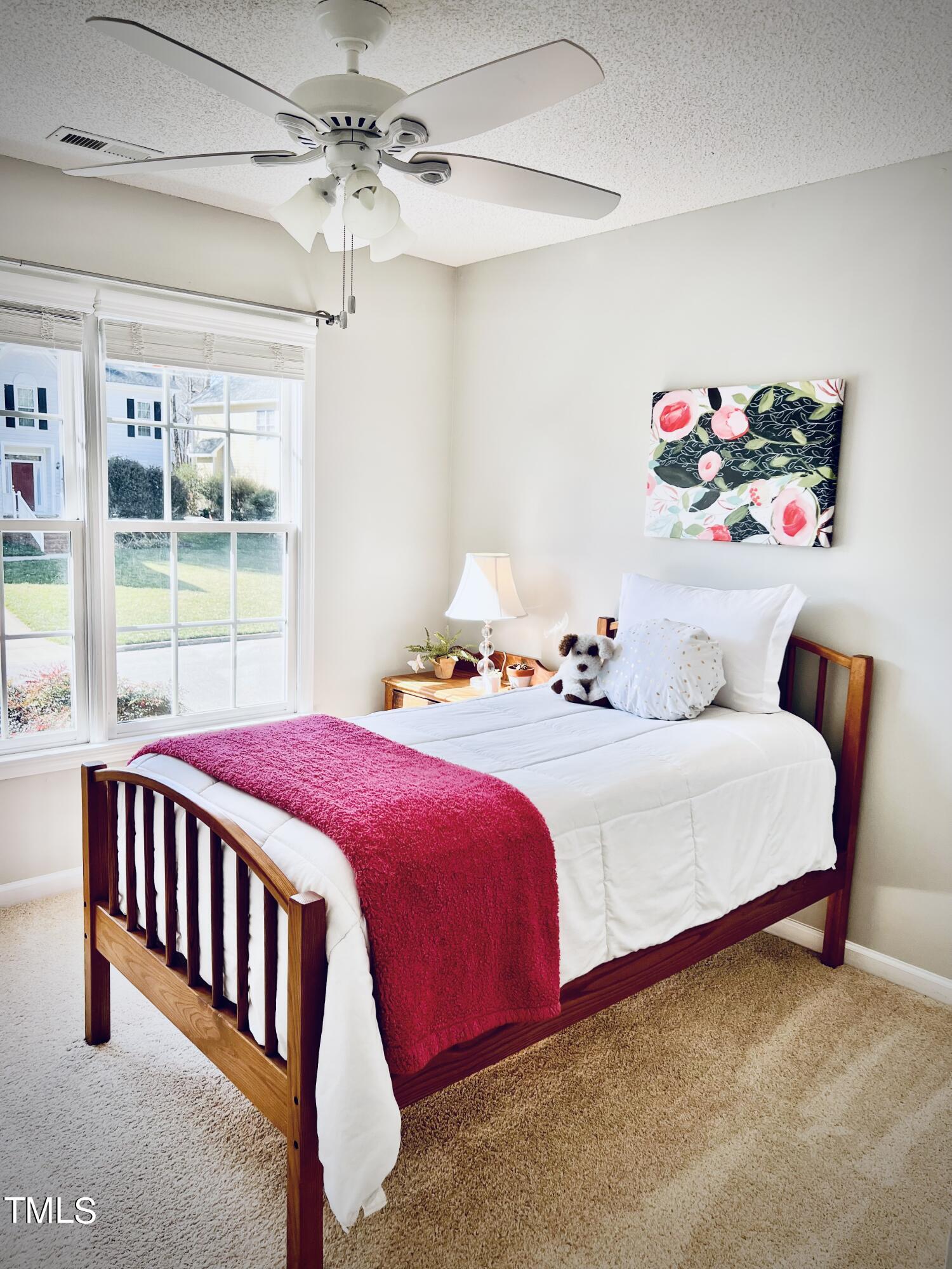 9013 Miranda Drive Raleigh, NC 27617 - Photo 19 of 41 a bedroom with a bed and a window