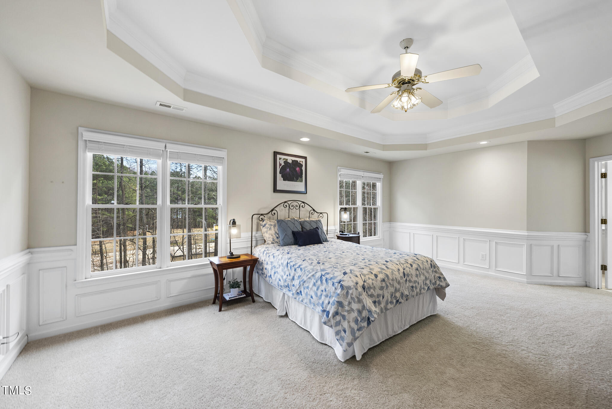 9013 Miranda Drive Raleigh, NC 27617 - Photo 22 of 41 a bedroom with a large bed and a chandelier fan