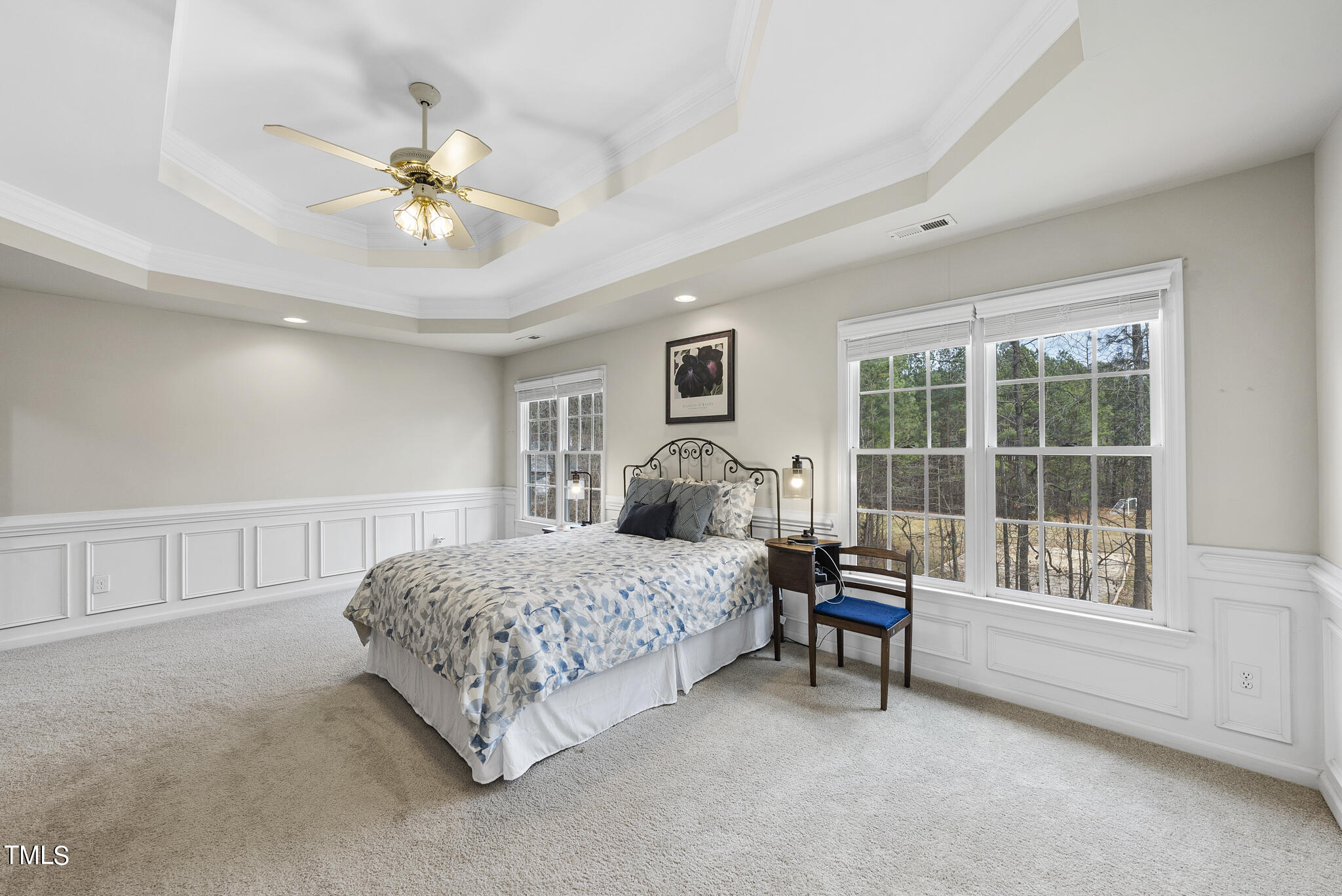 9013 Miranda Drive Raleigh, NC 27617 - Photo 23 of 41 a bedroom with a bed and a chandelier