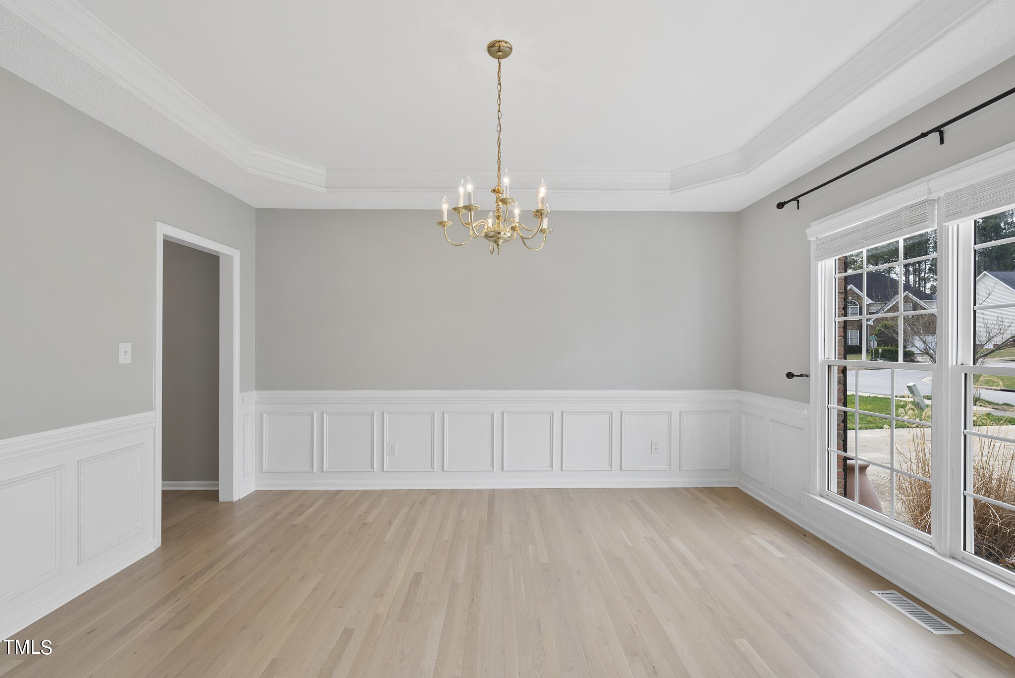 9013 Miranda Drive Raleigh, NC 27617 - Photo 6 of 41 wooden floor in an empty room with a window