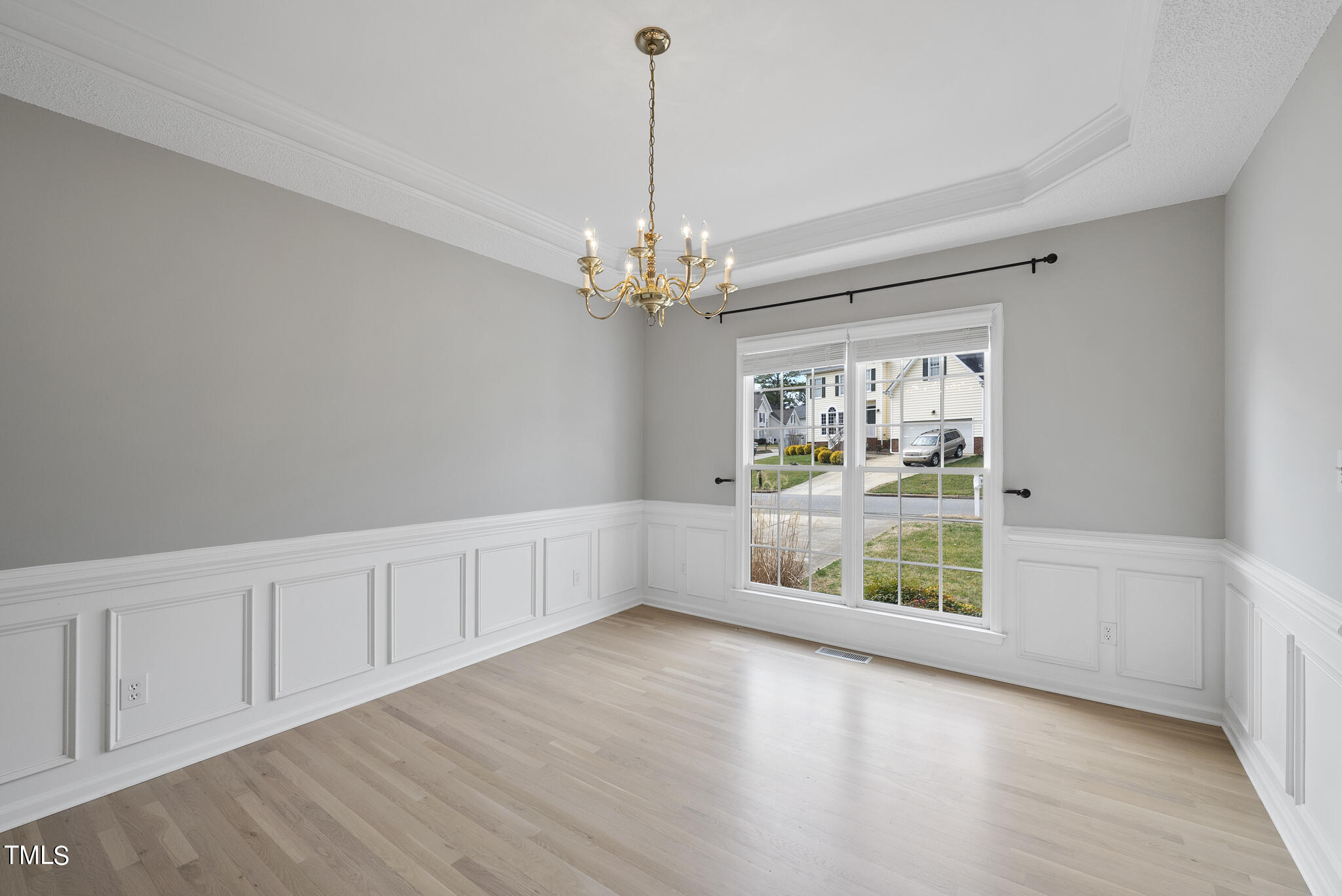 9013 Miranda Drive Raleigh, NC 27617 - Photo 7 of 41 a view of an empty room with window and chandelier fan
