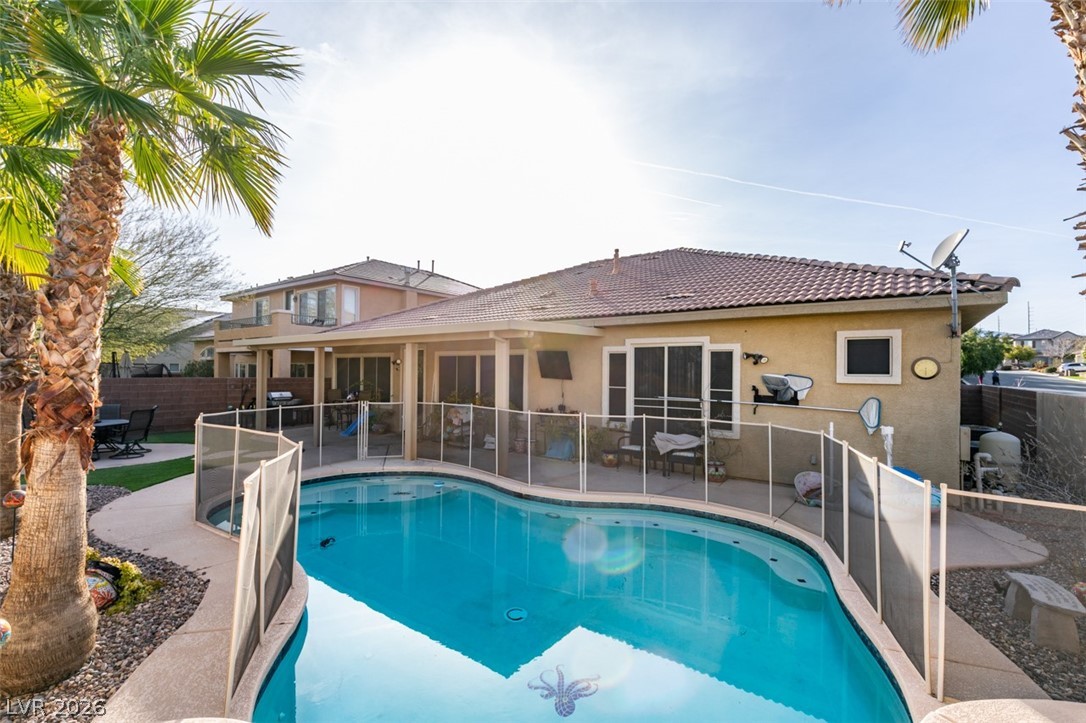 7524 Midnight Rambler Street Las Vegas, NV 89149 - Photo 47 of 51 An inviting backyard oasis offers a sparkling pool and a covered patio, perfect for outdoor enjoyment.