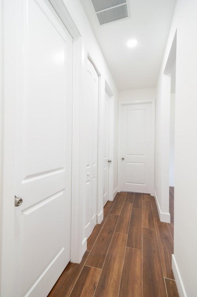 15061 Brainbridge Circle Port Charlotte, FL 33981 - Photo 11 of 21 a view of a hallway with wooden floor