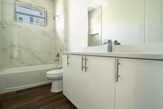 a bathroom with a toilet a sink and bathtub