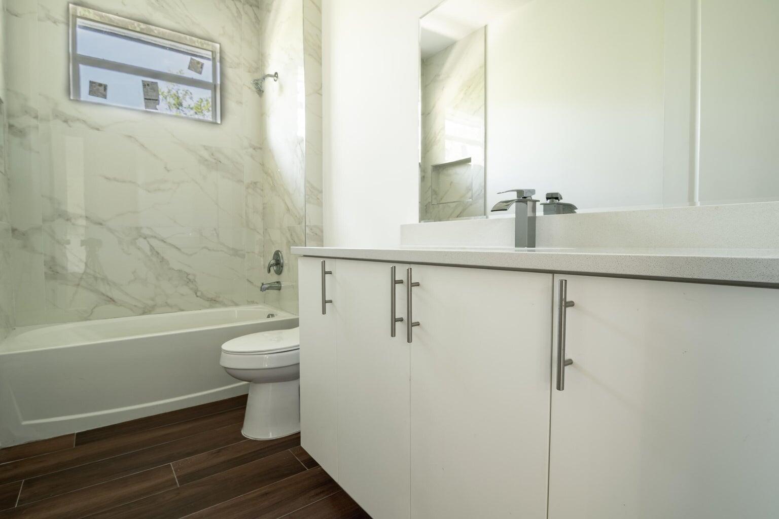 15061 Brainbridge Circle Port Charlotte, FL 33981 - Photo 13 of 21 a bathroom with a toilet a sink and bathtub