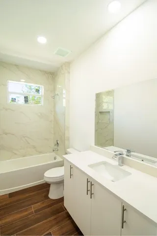a bathroom with a sink a toilet and bathtub