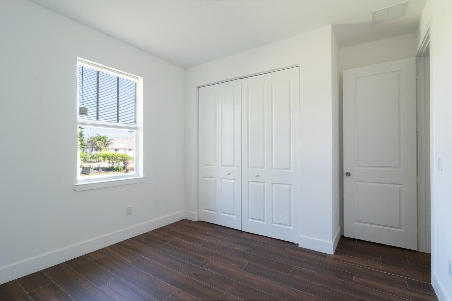 15061 Brainbridge Circle Port Charlotte, FL 33981 - Photo 15 of 21 an empty room with wooden floor and windows