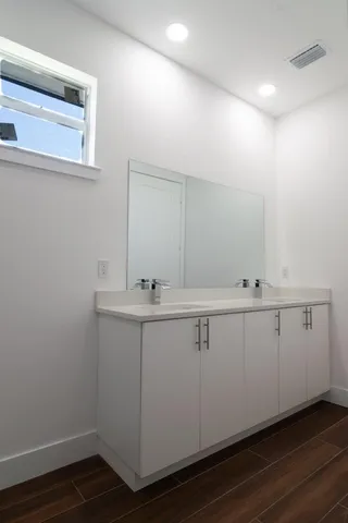 a bathroom with a sink and mirror