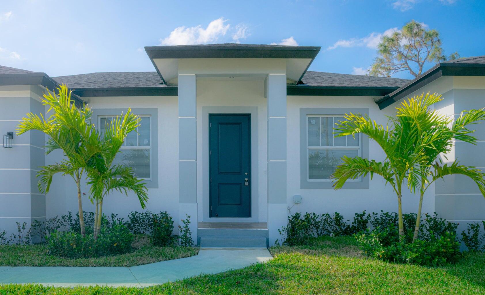 15061 Brainbridge Circle Port Charlotte, FL 33981 - Photo 2 of 21 a front view of a house with a yard