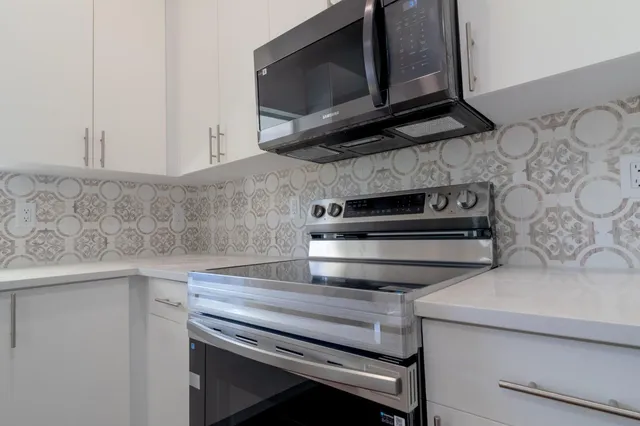 a kitchen with a stove microwave and sink