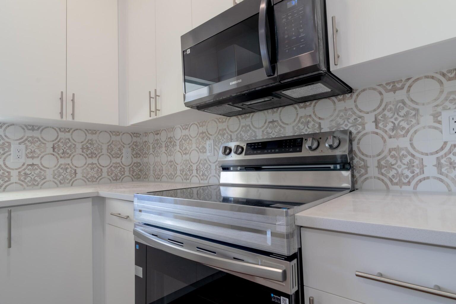15061 Brainbridge Circle Port Charlotte, FL 33981 - Photo 9 of 21 a kitchen with a stove microwave and sink
