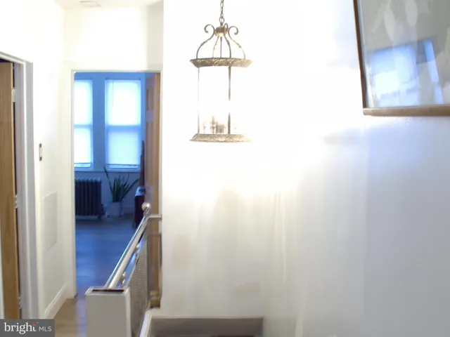 a hallway with a door and a mirror