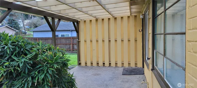 a view of a house with a yard and wooden fence