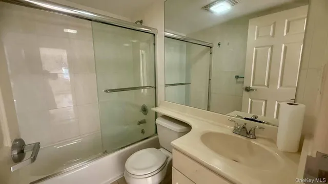 a view of empty room with wooden floor and window