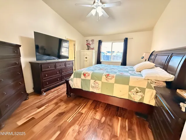 a bedroom with a bed and flat screen tv
