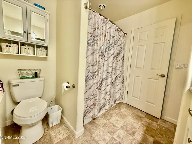 a bathroom with a toilet and shower