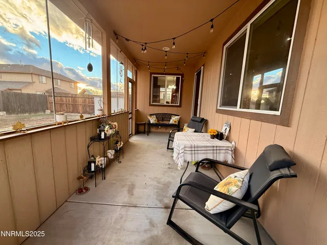 a view of a chairs and table in the balcony