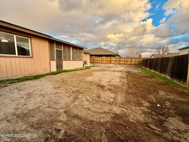 a view of a backyard of the house