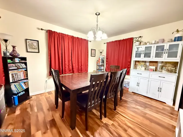 a view of a a dining room with furniture window and wooden floor